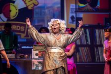 Hairspray Production photo. Motormouth Maybelle singing onstage wearing a gold jumpsuit.