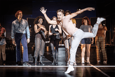 A Chorus Line Production shot. Redmand Rance (Mike Costa) is dancing solo in a way it makes it look like his is runing. The other members of the cast are looking at him, impressed by his dancing.