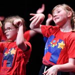 Children dancing on a stage