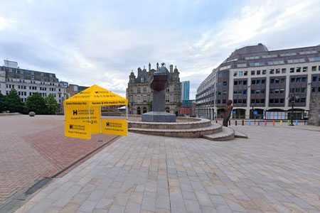 Access & Info Point - Victoria Square. Weekender Festival image. A small yellow tent next to the statue of Queen Victoria on Victoria Square.