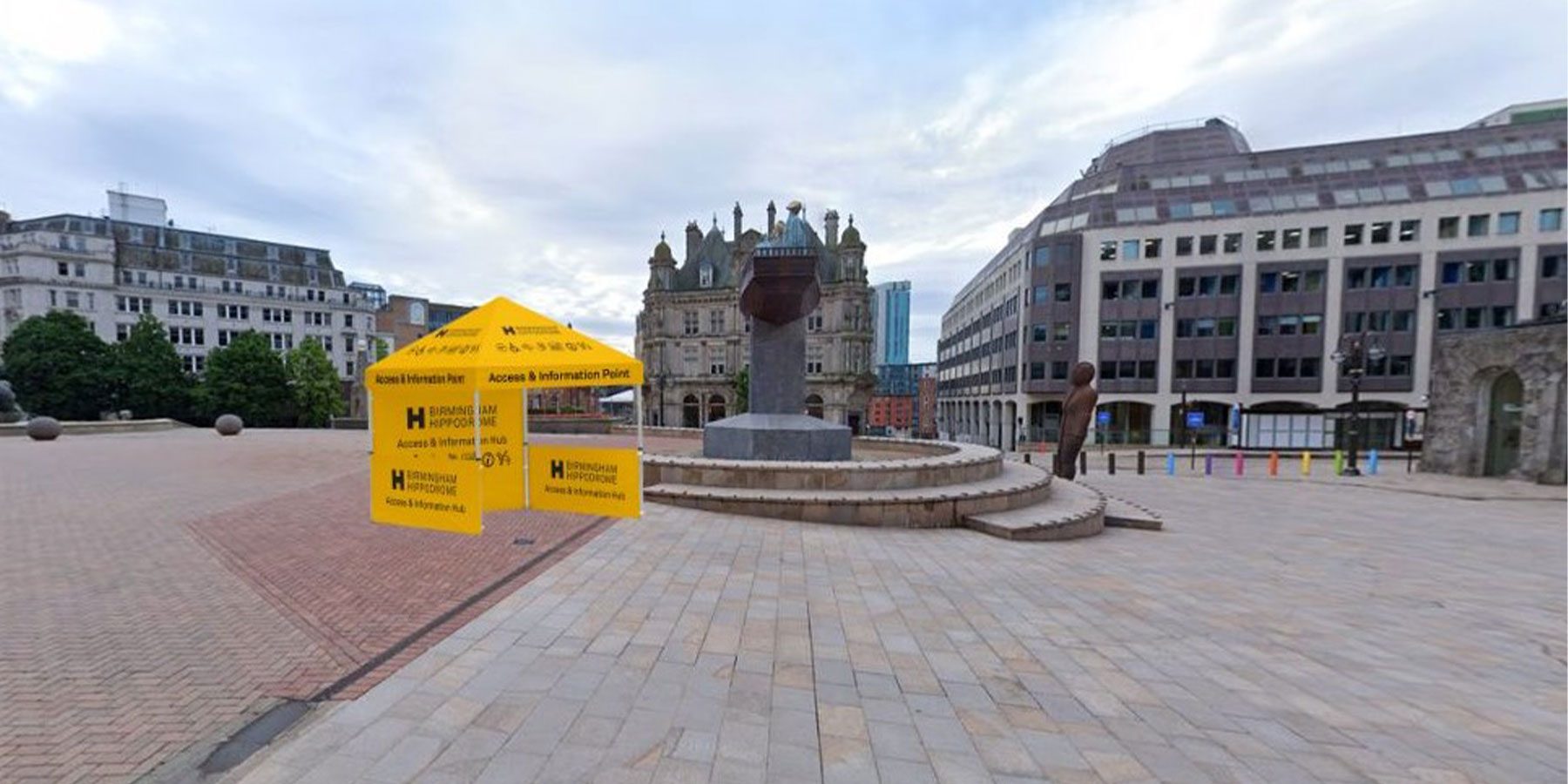 Access & Info Point - Victoria Square. Weekender Festival image. A small yellow tent next to the statue of Queen Victoria on Victoria Square.