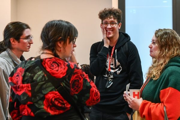 Group of people standing together in conversation.