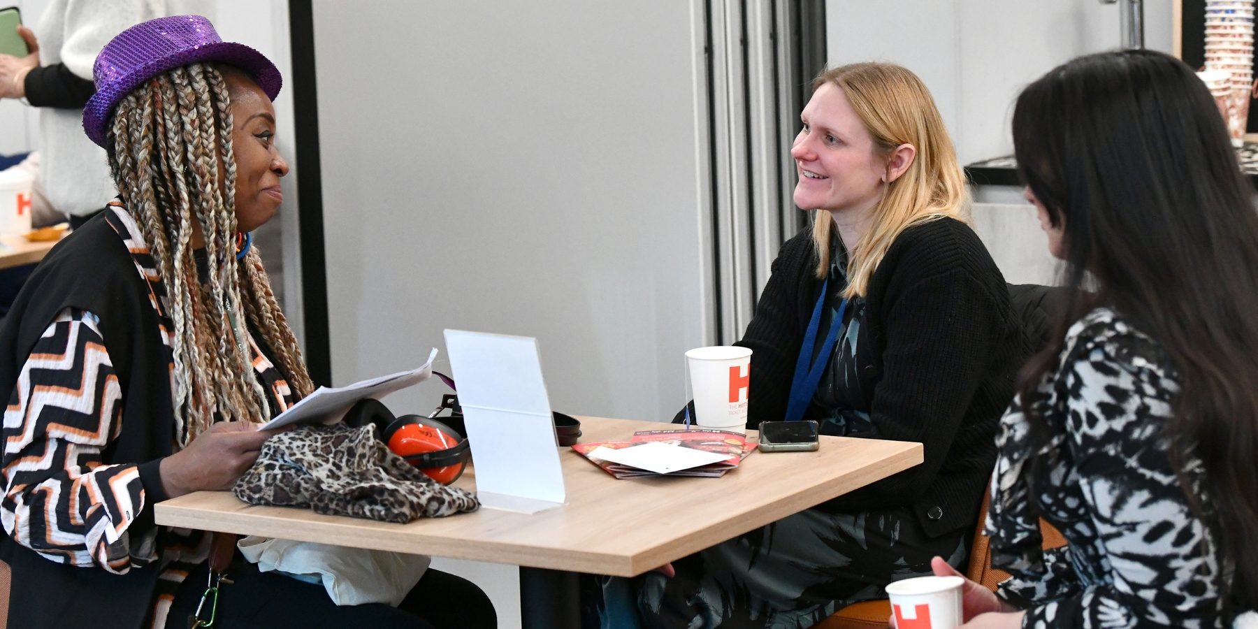 Three people sitting at a table together.