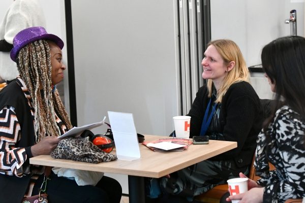 Three people sitting at a table together.