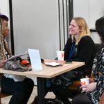 Three people sitting at a table together.