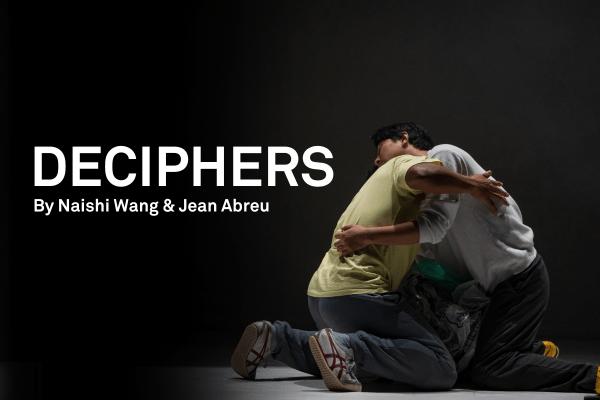 Two people on the floor embracing each other over the shoulders