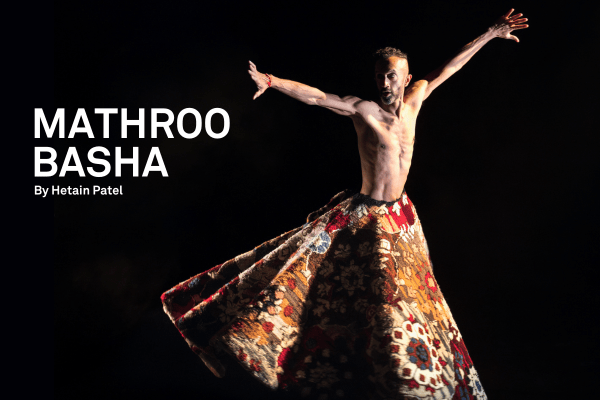 man in traditional clothing dancing with arms wide