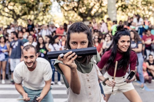 Three dancers performing in crowd engaging with the camera and audiences.