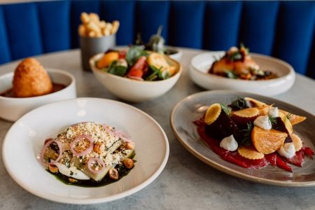 Plates of autumnal food laid on a table in an aesthetic way.